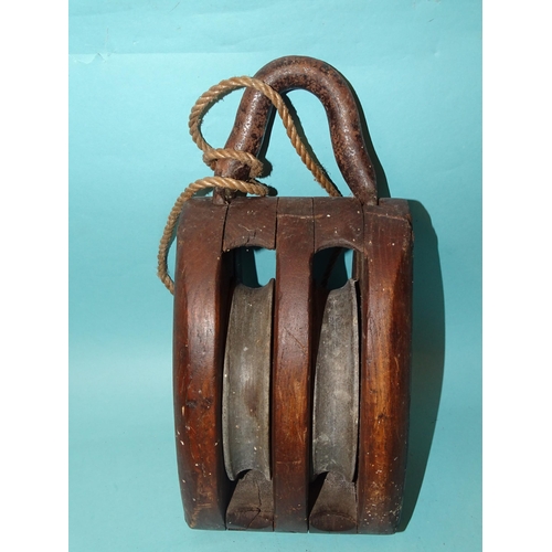 529 - An antique ships pulley block impressed Alan Best Ltd, with twin cast iron roller wheels, 32cm long ... 