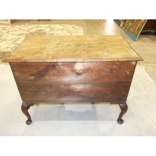 110 - An antique walnut feather-banded lowboy, the rectangular quarter-veneered top with moulded edge, abo... 