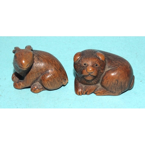 147 - A carved wood netsuke of a hare, signed beneath, 3 x 4cm and another of a feline animal, (2).... 