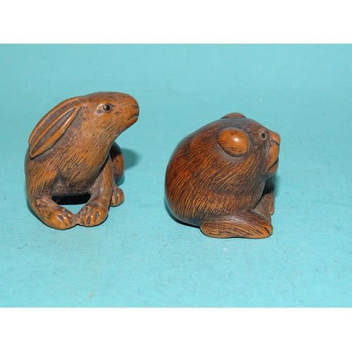 147 - A carved wood netsuke of a hare, signed beneath, 3 x 4cm and another of a feline animal, (2).... 