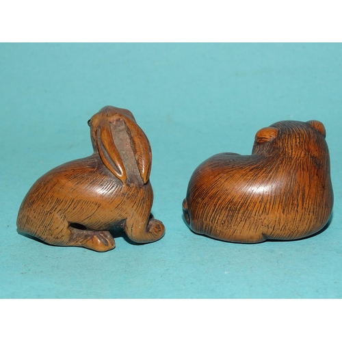 147 - A carved wood netsuke of a hare, signed beneath, 3 x 4cm and another of a feline animal, (2).... 