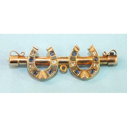 212 - An Edwardian bar brooch, the yellow gold bar with a pair of horseshoes, alternately-set round-cut sa... 