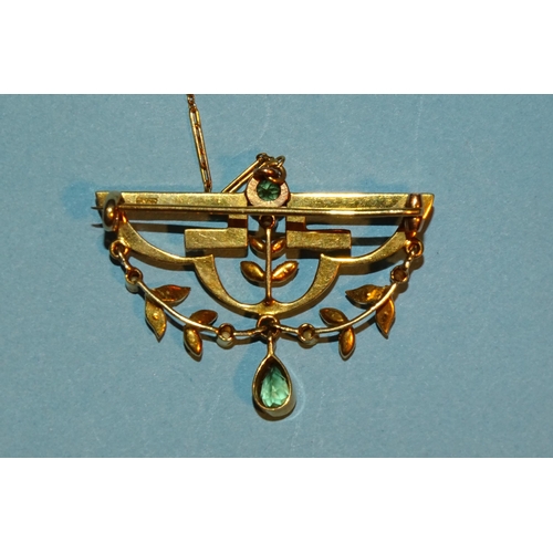 243 - An Edwardian 15ct gold brooch, the upper part of geometric design set seed pearls and peridot, with ... 