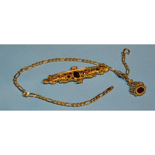 256 - A modern 9ct gold brooch set three garnets and a small garnet pendant on 9ct gold bracelet, 4.2g, (2... 