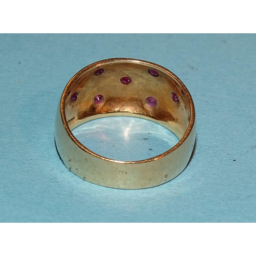 347 - A gold ring set seven small round-cut rubies, marked '750', M,  5.5g.