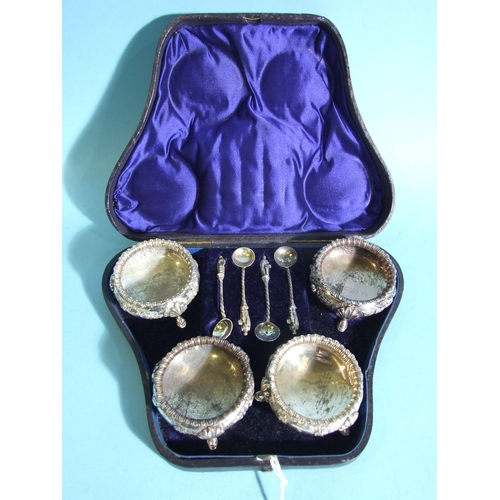 562 - A Victorian cased set of four silver salts, each of circular form with embossed floral decoration, o... 