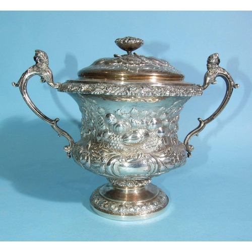 563 - A William IV silver porringer and cover, of bellied form with scrolling caryatid handles, embossed o... 