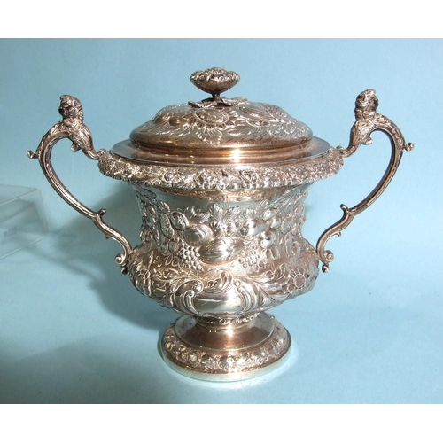 563 - A William IV silver porringer and cover, of bellied form with scrolling caryatid handles, embossed o... 