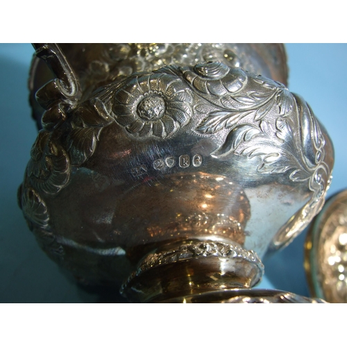 563 - A William IV silver porringer and cover, of bellied form with scrolling caryatid handles, embossed o... 