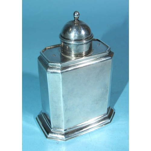 571 - A George I silver tea caddy of rectangular shape with chamfered corners, sliding top with finialled ... 