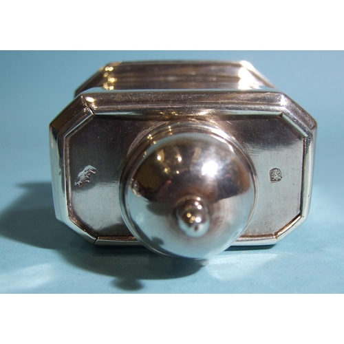 571 - A George I silver tea caddy of rectangular shape with chamfered corners, sliding top with finialled ... 