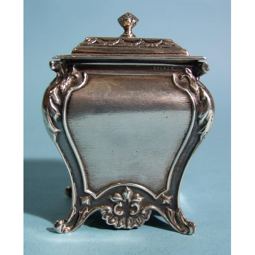 572 - A late-Victorian rectangular tea caddy of bombe shape, embossed with ribbon-tied musical instruments... 