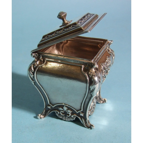 572 - A late-Victorian rectangular tea caddy of bombe shape, embossed with ribbon-tied musical instruments... 