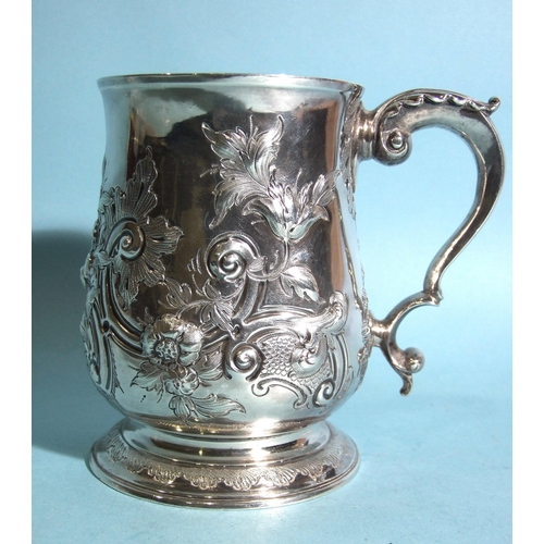 583 - A George III baluster tankard by Charles Wright, with leaf-capped scroll handles and foliate embossi... 