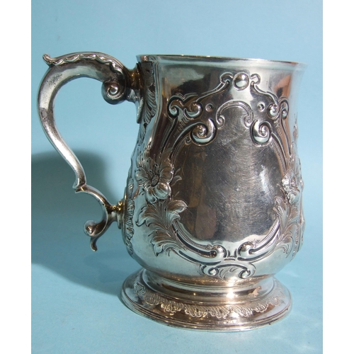 583 - A George III baluster tankard by Charles Wright, with leaf-capped scroll handles and foliate embossi... 