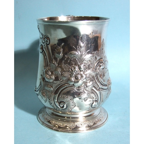 583 - A George III baluster tankard by Charles Wright, with leaf-capped scroll handles and foliate embossi... 