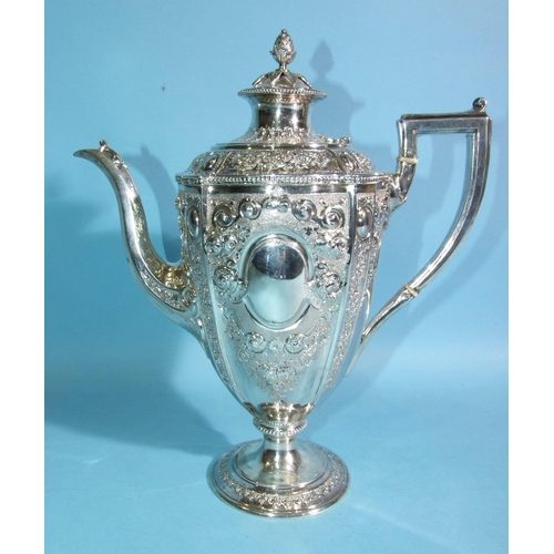 588 - A Victorian silver coffee pot of urn shape, decorated with flowers and scrolls, with beaded rims, on... 