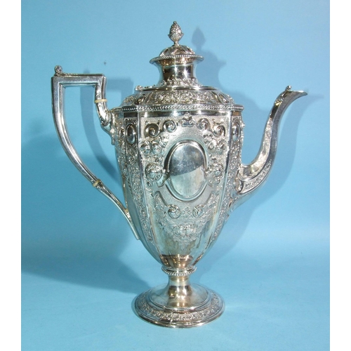 588 - A Victorian silver coffee pot of urn shape, decorated with flowers and scrolls, with beaded rims, on... 