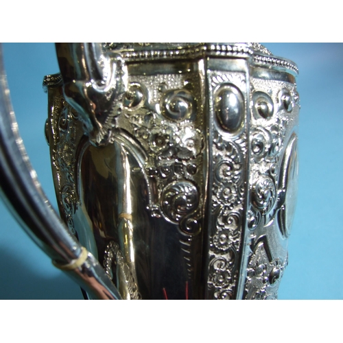 588 - A Victorian silver coffee pot of urn shape, decorated with flowers and scrolls, with beaded rims, on... 