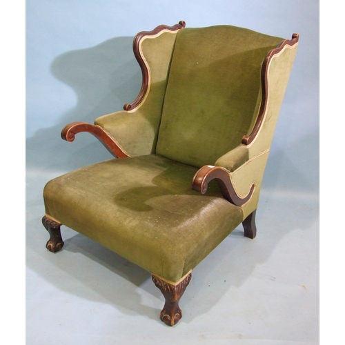 81 - A Victorian mahogany shaped armchair on claw and ball front legs.