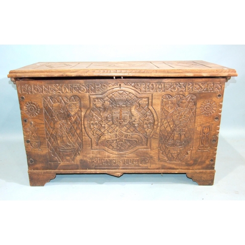 82 - A 20th century hardwood coffer chest, the front carved with heraldic symbols, Bath 