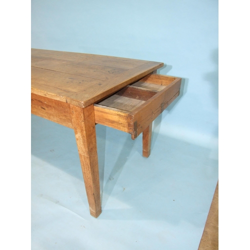 96 - A 19th century French chestnut farmhouse table, the three-planked top above two end drawers, on squa... 