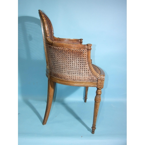 108 - A 19th century beech-framed and caned armchair, the reeded frame carved with leaves, husks and flowe... 