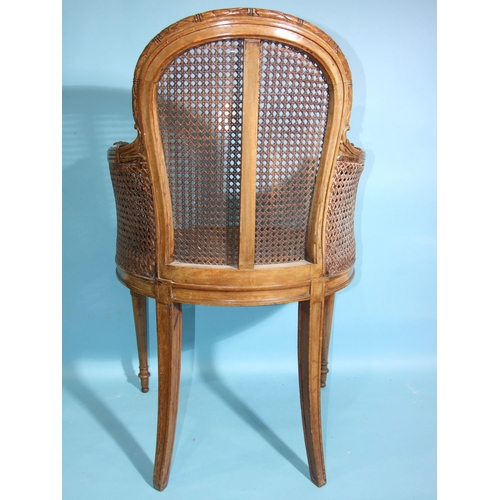 108 - A 19th century beech-framed and caned armchair, the reeded frame carved with leaves, husks and flowe... 