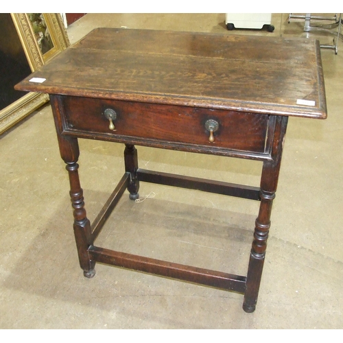 111 - An antique oak rectangular-top side table fitted with a single frieze drawer, on turned legs joined ... 