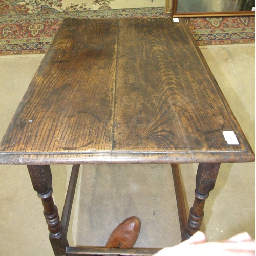 111 - An antique oak rectangular-top side table fitted with a single frieze drawer, on turned legs joined ... 