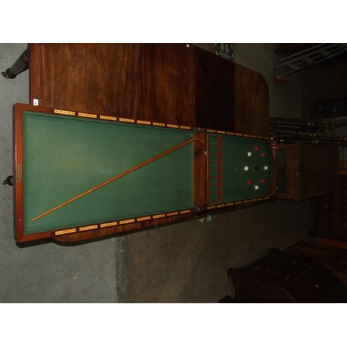 86 - A Victorian walnut folding bagatelle board, with balls and one cue, 242cm open, 121cm x 61cm closed.... 