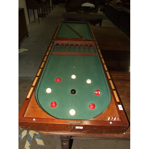 86 - A Victorian walnut folding bagatelle board, with balls and one cue, 242cm open, 121cm x 61cm closed.... 