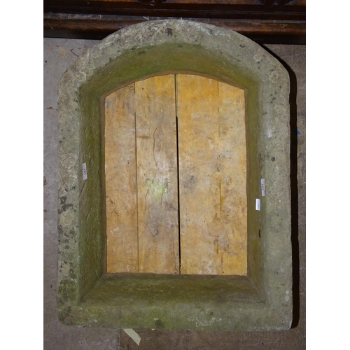 151 - A stone window opening with arched top, 70cm high, 53cm wide.