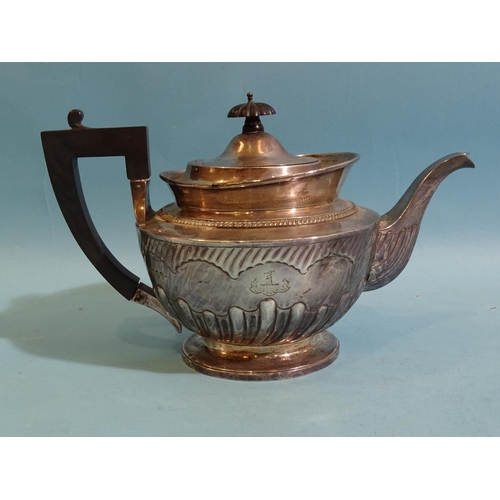 565 - A Victorian silver teapot of circular form with partial-gadrooned decoration, armorial and black han... 