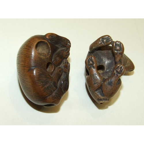 147 - A carved wood netsuke of a hare, signed beneath, 3 x 4cm and another of a feline animal, (2).... 