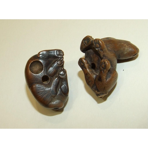 147 - A carved wood netsuke of a hare, signed beneath, 3 x 4cm and another of a feline animal, (2).... 