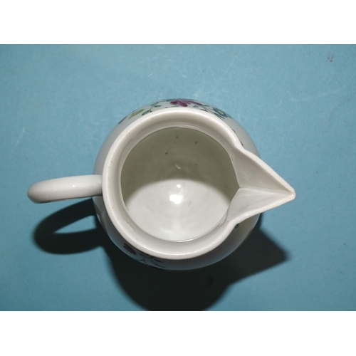 121 - A Bristol famille rose cream jug, 9cm high, (tiny chip to spout tip).