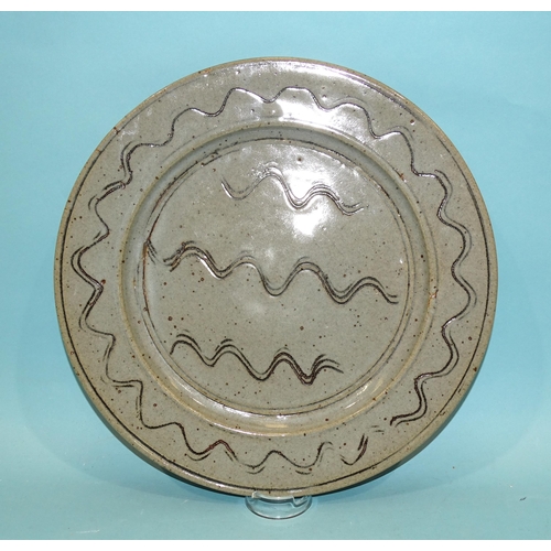 127 - Ray Finch, Winchcombe Pottery, a circular glazed charger decorated with incised wavy lines, 32cm dia... 