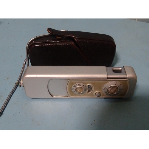 151 - A Minox sub-miniature camera, cased, with accessories: flash gun attachment, (cased), binocular adap... 