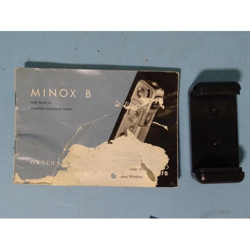 151 - A Minox sub-miniature camera, cased, with accessories: flash gun attachment, (cased), binocular adap... 