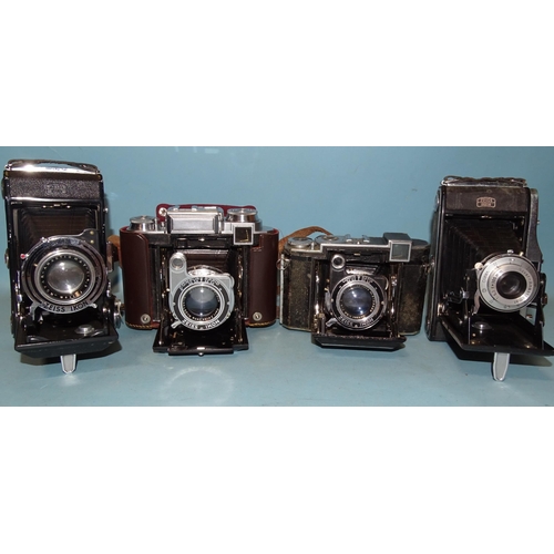 247 - Zeiss Ikon folding cameras: two Super Ikonta cameras with f2.8 8cm lenses, a Nettar and one other, (... 