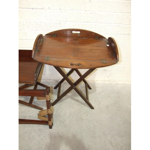 61 - A Victorian mahogany butler's tray, the panelled tray with brass hinged rounded folding gallery, on ... 