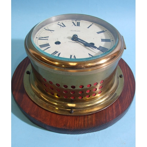 85 - A 20th century Celeste brass bulkhead clock striking on a bell, 20cm diameter.