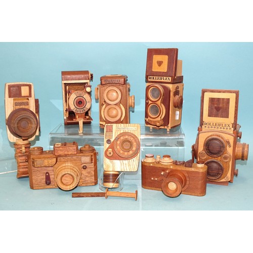 422 - Eight scratch-built wooden camera models: two Leicas, three Rolleiflex, a Canon Dial 35, a Kodak fol... 