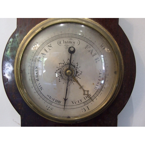 87 - A mahogany wheel barometer, the narrow case with silvered dry/damp, thermometer and spirit level dia... 