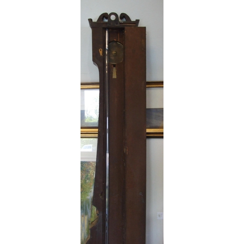 87 - A mahogany wheel barometer, the narrow case with silvered dry/damp, thermometer and spirit level dia... 