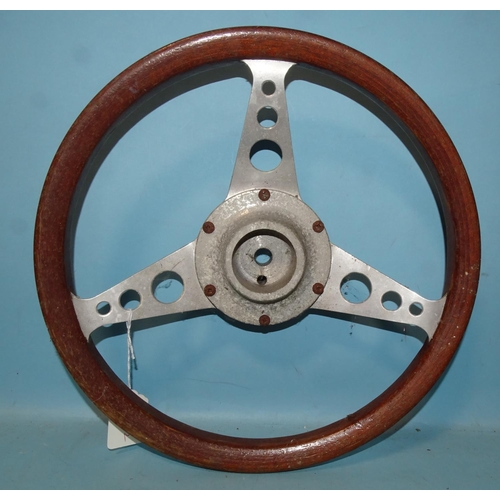 527 - A vintage aluminium and wood three-spoke steering wheel, 33cm diameter.