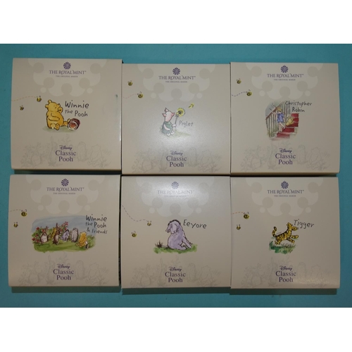 418 - The Royal Mint, 'Winnie The Pooh', a collection of six cased silver proof 50-pence coins, comprising... 