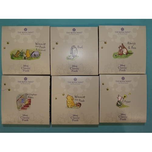 419 - The Royal Mint, 'Winnie The Pooh', a collection of six cased silver proof 50-pence coins, comprising... 