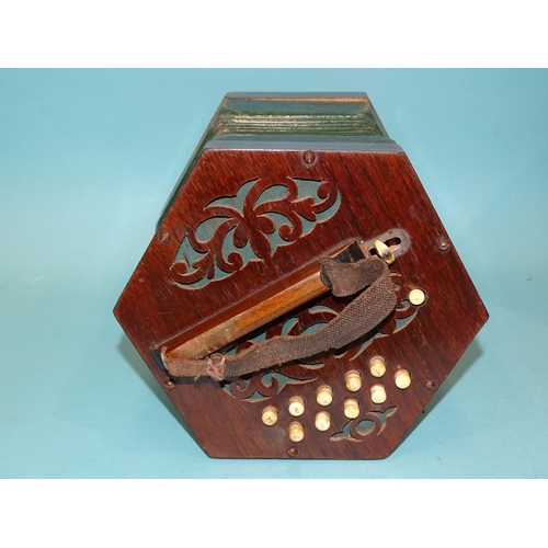 530A - A twenty-one key rosewood concertina with tooled leather and paper bellows, in fitted box.... 